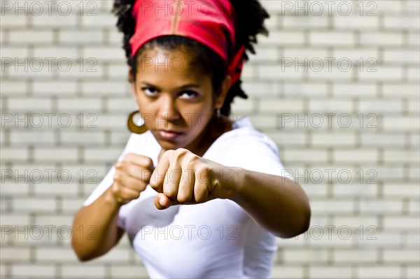 Serious Mixed Race woman posing with fists