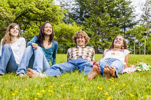 Friends sitting and laying in grass