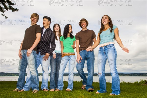 Smiling friends posing near river