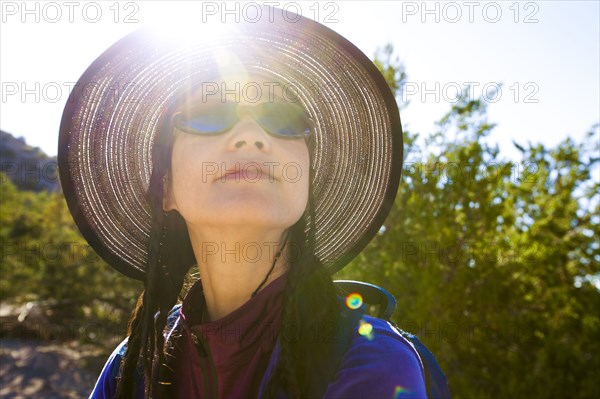 Back lit Japanese woman in sunny forest