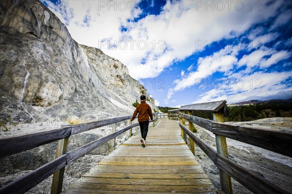 Japanese woman walking on boardwalk