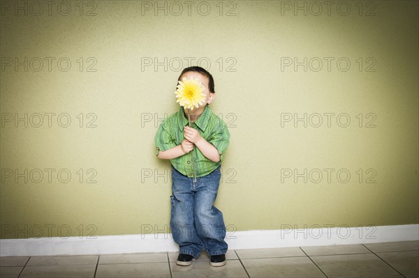 Mixed Race boy holding flower