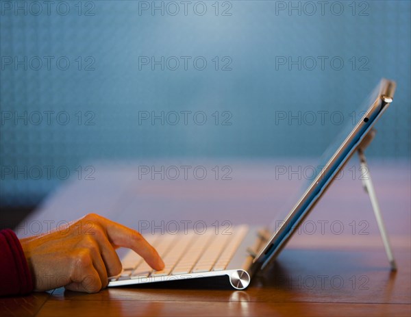 Finger of Japanese woman pressing keyboard for digital tablet
