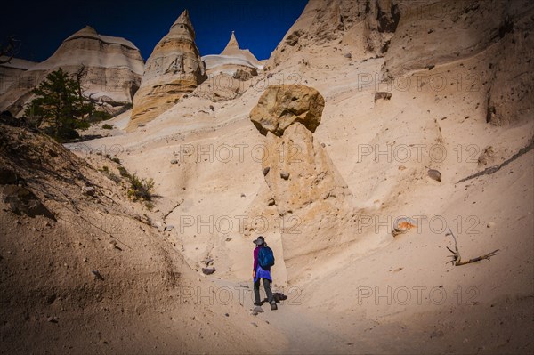 Japanese woman hiking in desert canyon