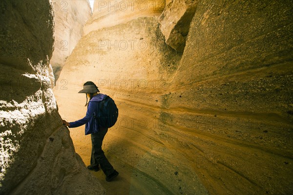 Japanese woman hiking between canyon walls