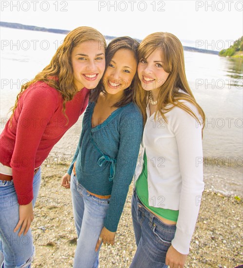 Portrait of smiling girls posing at beach