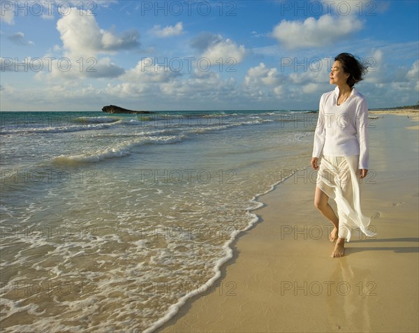 Japanese woman walking on beach