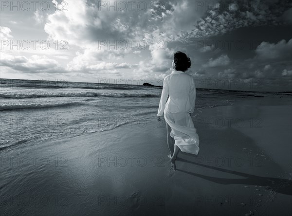 Japanese woman walking on beach