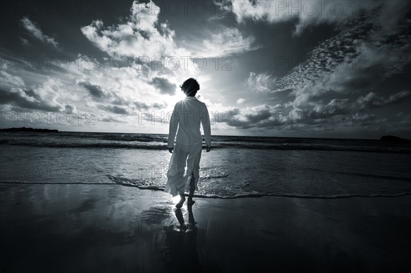 Japanese woman walking on beach