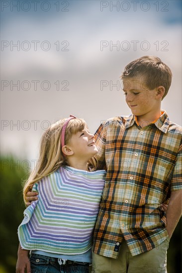 Caucasian brother and sister hugging