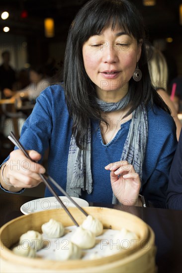 Japanese woman eating food with chopsticks