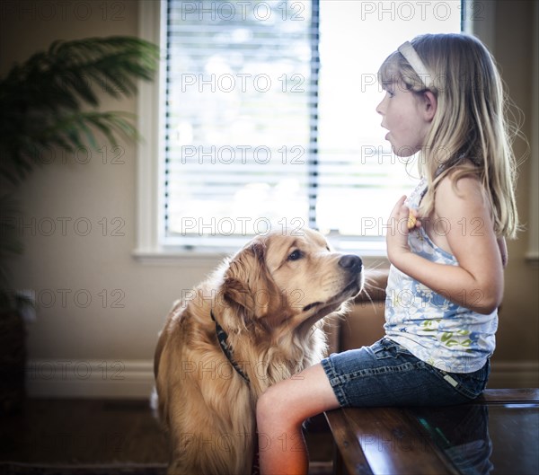 Curious dog sniffing food of Caucasian girl