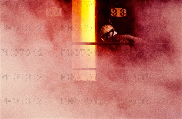 Person wearing mask in smoke