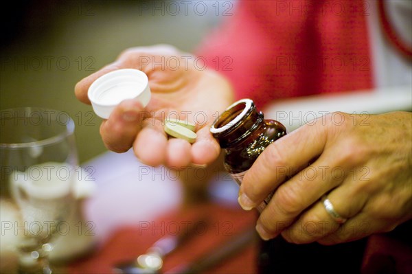 Hands of Caucasian woman holding supplements