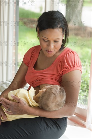 Mother breast feeding child