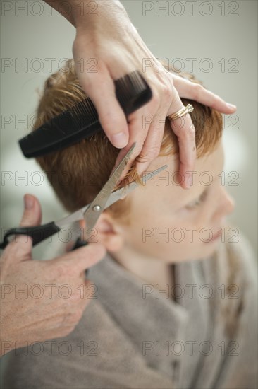 Caucasian mother giving son haircut