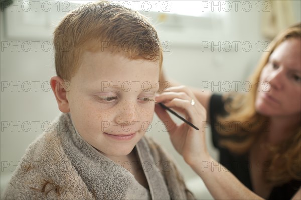 Caucasian mother giving son haircut