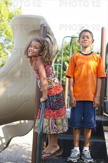 Mixed race children playing on playground