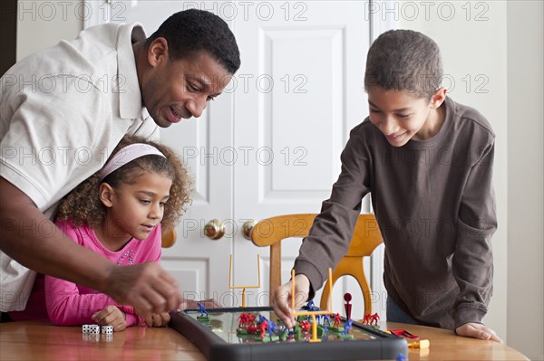 Family playing board game together