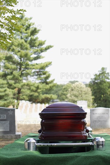 Coffin lowering into grave in military cemetery