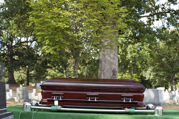 Coffin lowering into grave in military cemetery