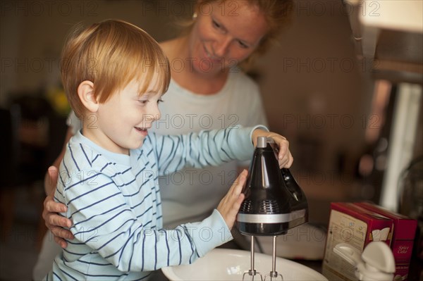 Caucasian mother and son baking in kitchen