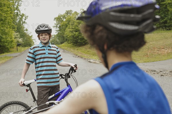 Boys riding bicycles together outdoors