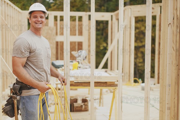 Caucasian construction worker smiling on site