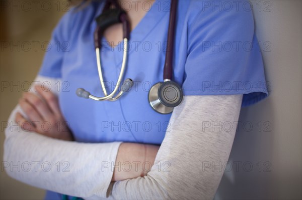 Caucasian nurse wearing stethoscope in hospital