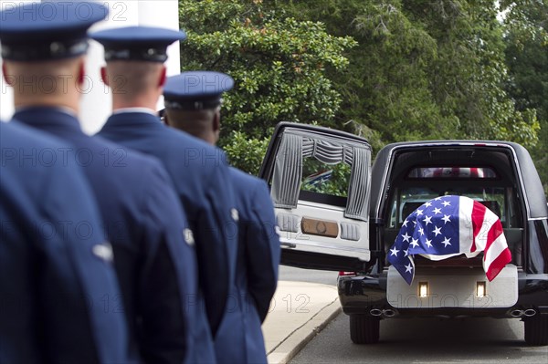 Soldiers watching casket at military funeral