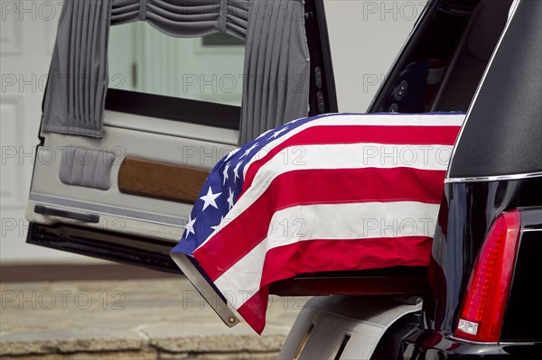 American flag over casket at military funeral