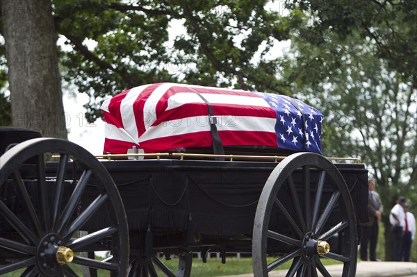 American flag over casket at military funeral