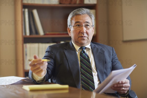 Mixed race businessman talking in office