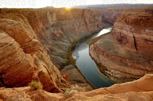 River winding through majestic rock formations in desert landscape