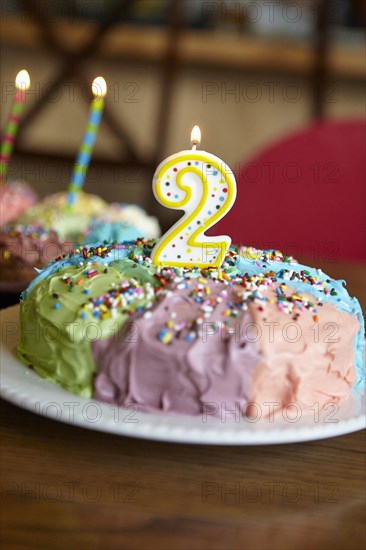 Close up of birthday cake with number two candle