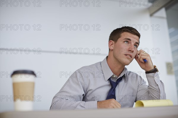 Caucasian businessman sitting in office