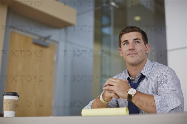 Caucasian businessman sitting in office