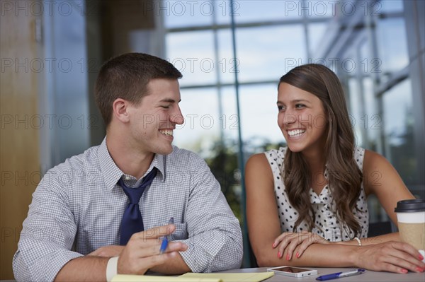 Business people laughing in office meeting