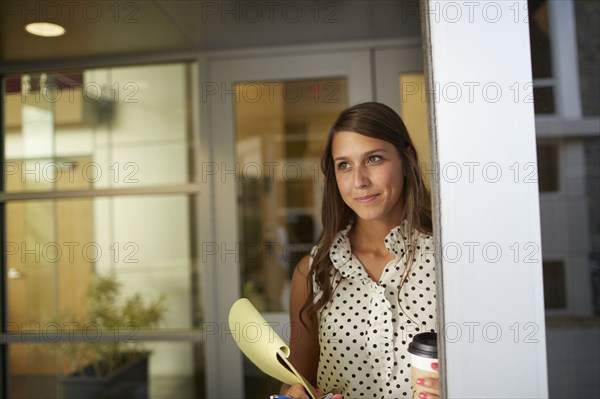 Mixed race businesswoman standing in office