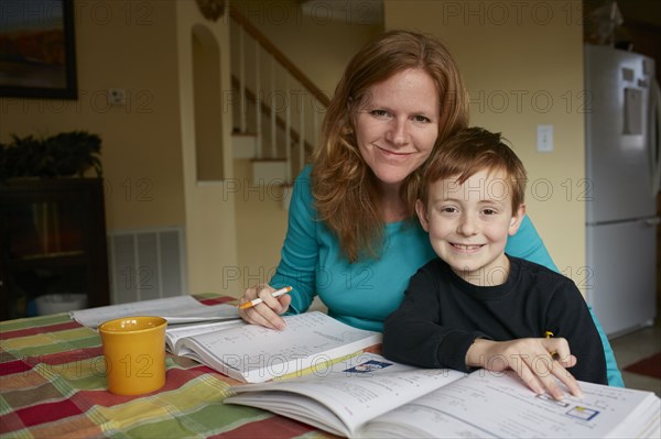 Caucasian mother helping son do homework