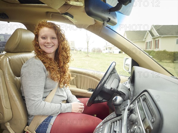 Caucasian teenage girl driving car