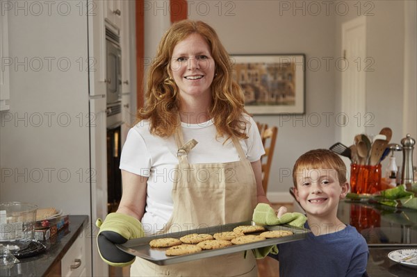 Caucasian mother and son baking cookies in kitchen