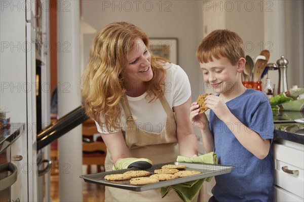 Caucasian mother and son baking cookies in kitchen