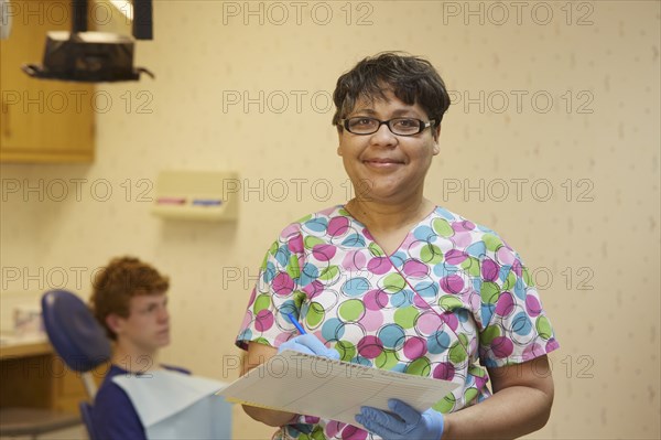 Pediatric dentist smiling in office