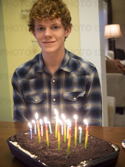 Caucasian boy smiling with birthday cake