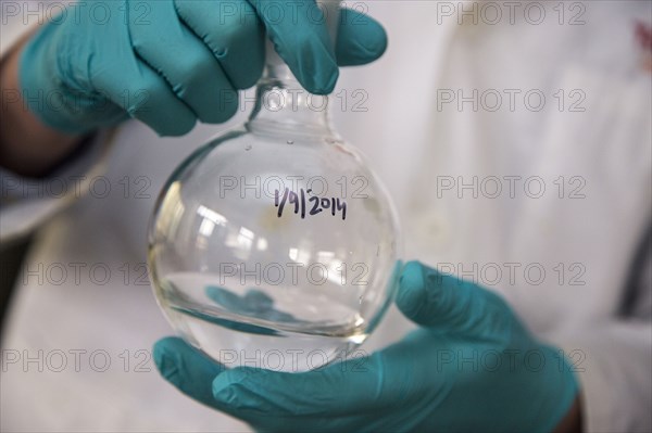 Mixed race scientist mixing solution in lab