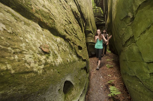 Caucasian couple exploring cave