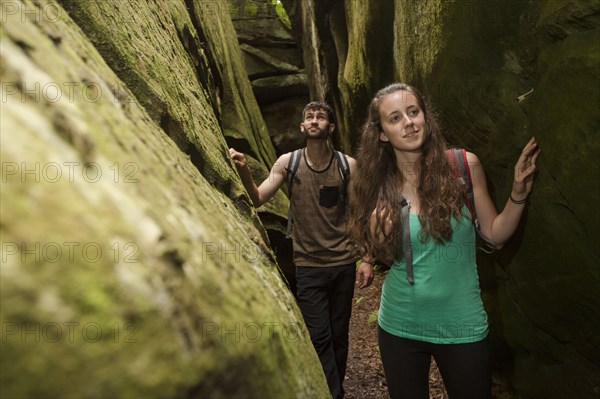 Caucasian couple exploring cave