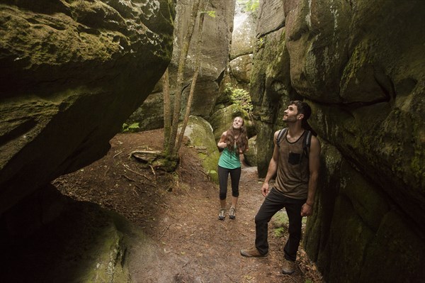 Caucasian couple exploring cave