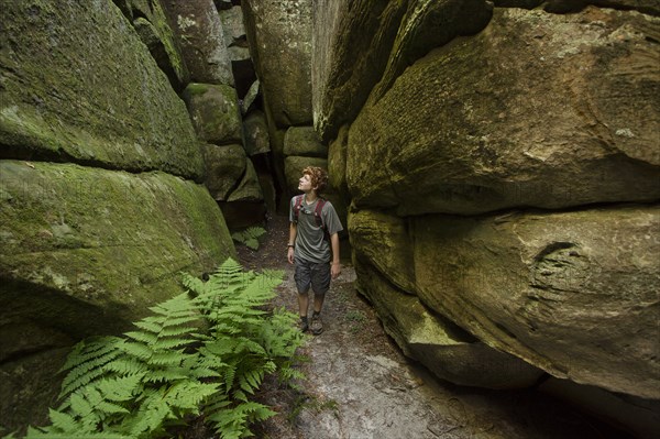 Caucasian teenage boy exploring cave